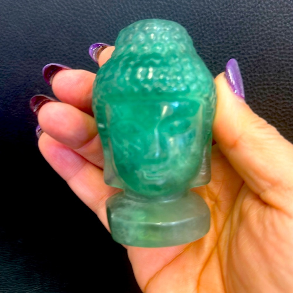 A set of two Buddha. The larger one is fluorite the baby one is adventurine.